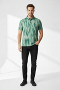 Front view - model wearing green tie-dye polo with black jeans