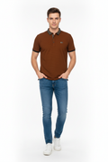 Young man wearing brown polo shirt and jeans