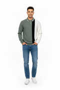 Young man wearing gray color-blocked polo sweatshirt and jeans
